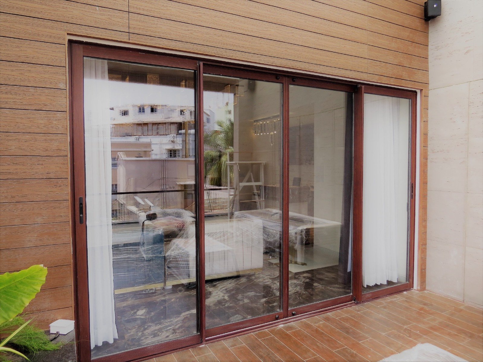 Bronze aluminium sliding doors across a terrace