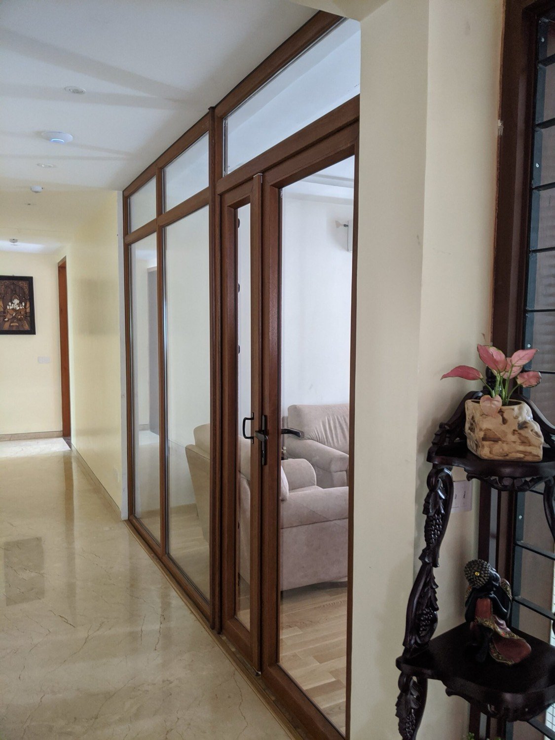 A hallway lined with wood-finish uPVC casement windows and doors